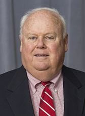 James T. Morris smiling for a photograph.